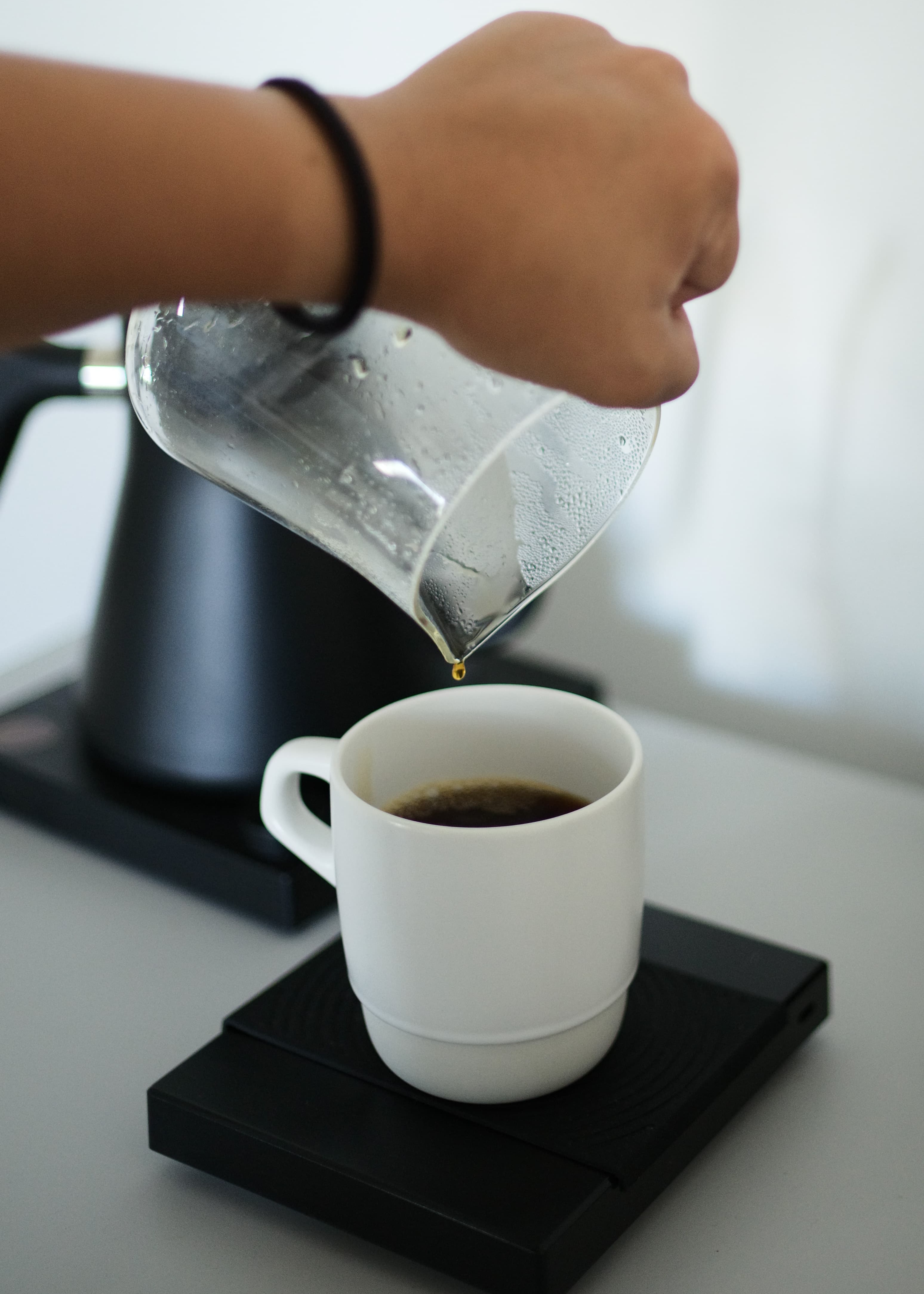 Pouring over a lastop drop of coffee to a cup